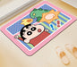 Colorful mat with a cartoon character and dinosaur on a light wooden floor.